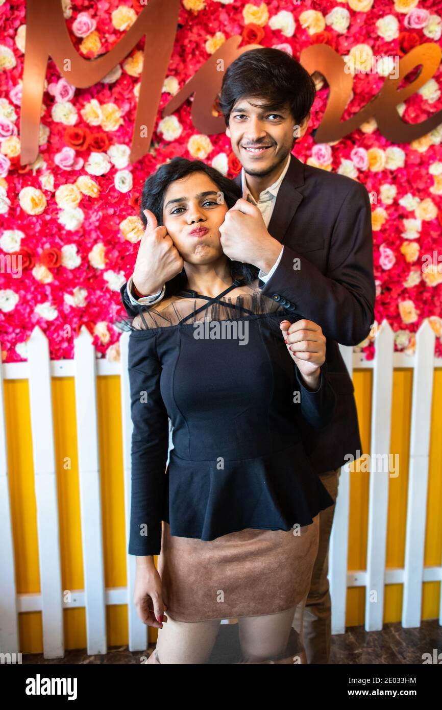 Smiling young couple showing a red heart to the camera on Valentine's day in India